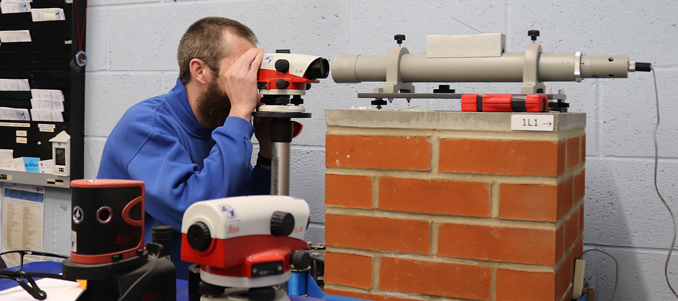 Jordan checking an automatic level in the YSSC workshop